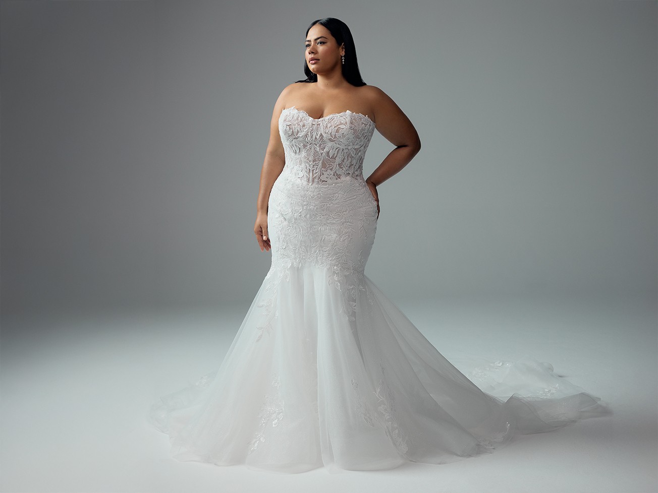 Plus size model in white Sophia Tolli dress