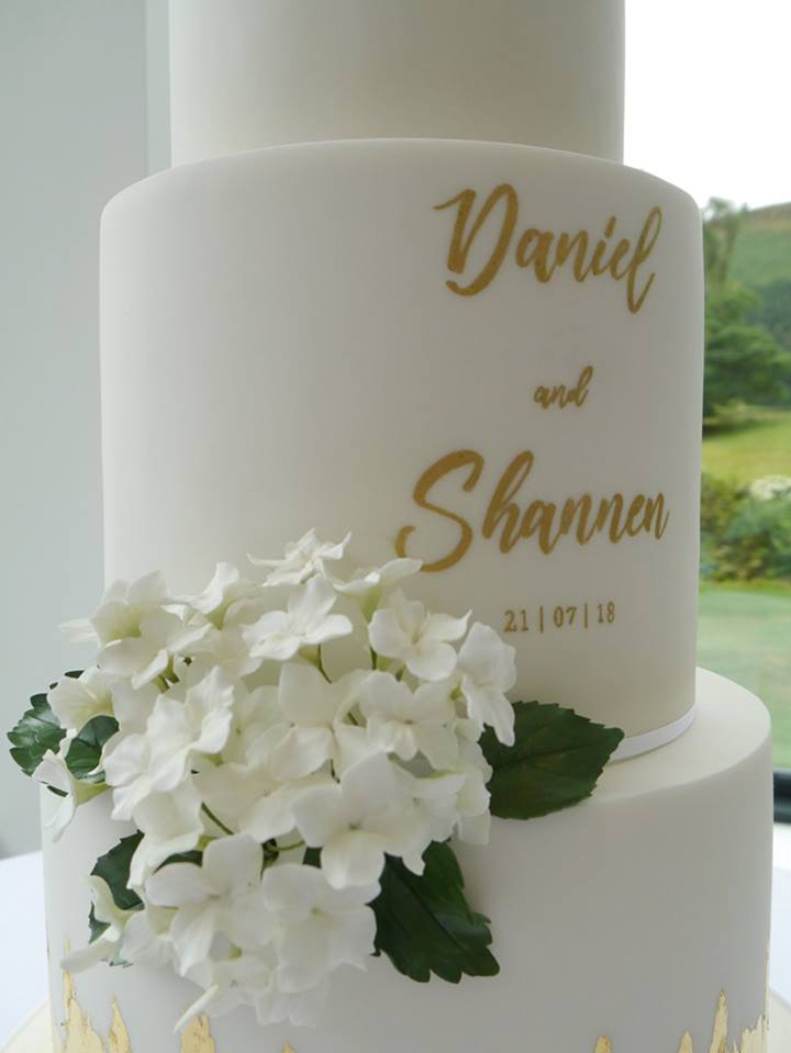 Contemporary White Wedding Cake With Hand-Painted Calligraphy & Gold Leaf