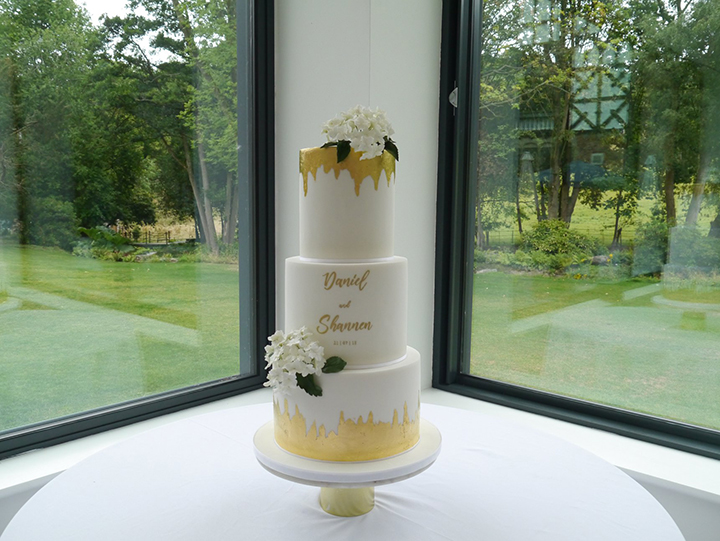 Contemporary White Wedding Cake With Hand-Painted Calligraphy & Gold Leaf